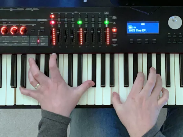 An overhead photo of my hands playing a sharp 11 chord