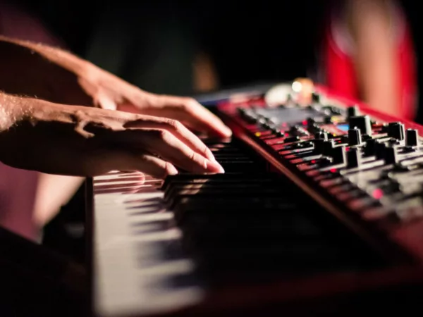 Hands on a synthesizer